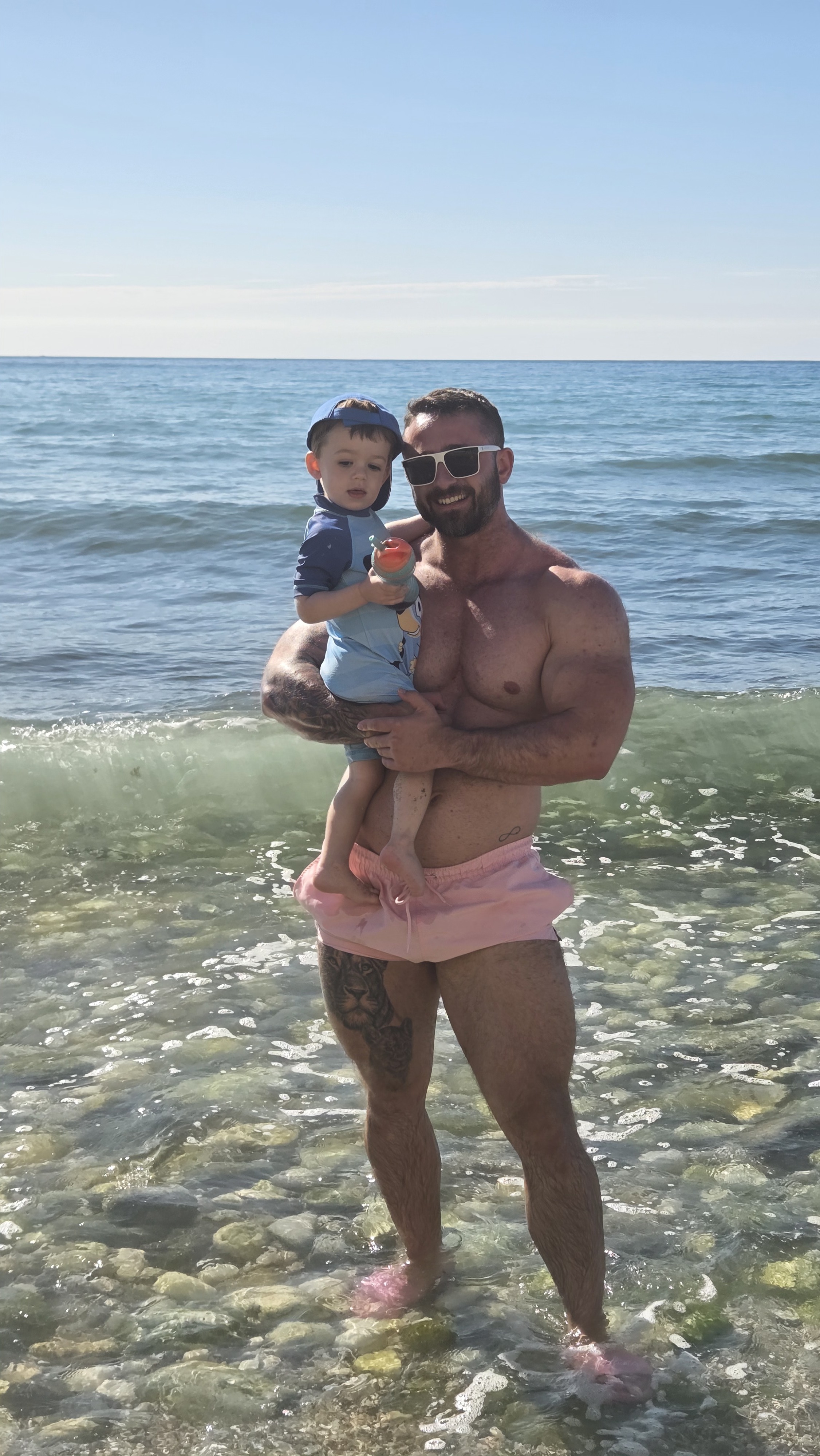 Josh King on the beach with his son